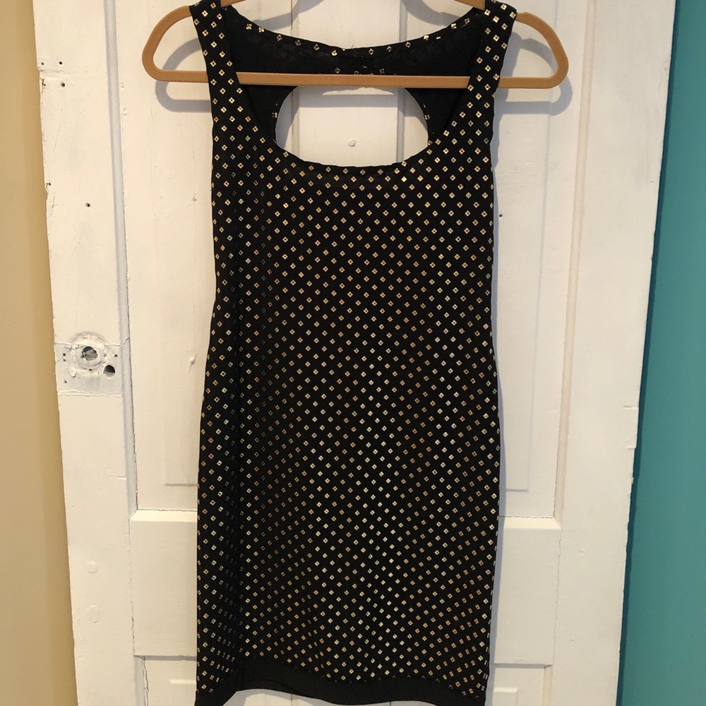 Sassy black mini dress with gold detail 🌟
